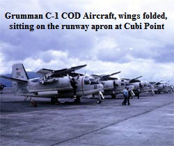 Grumman C-1 COD Aircraft, wings folded, 
sitting on the runway apron at Cubi Point