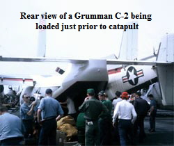 Rear view of a Grumman C-2 being 
loaded just prior to catapult